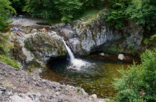 Tourists chilling in the waters of the waterfall.